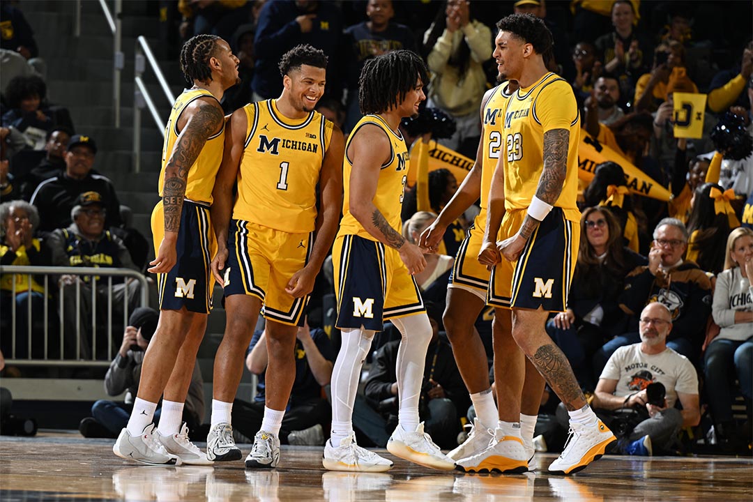 Men's basketball team celebrates a win on the court