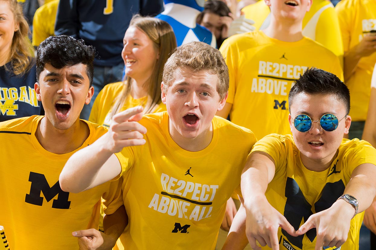 Fans cheering in maize t-shirts