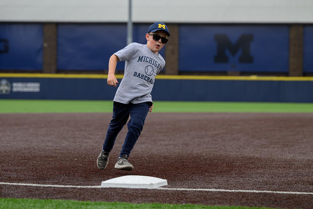 A kid running the bases at Ray Fisher Stadium