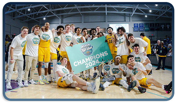 Men's basketball celebrates the Fort Myers Tip-Off Championship with the trophy