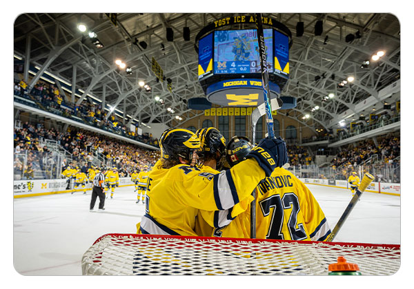 Players celebrating with Ivankovic after beating Western Michigan