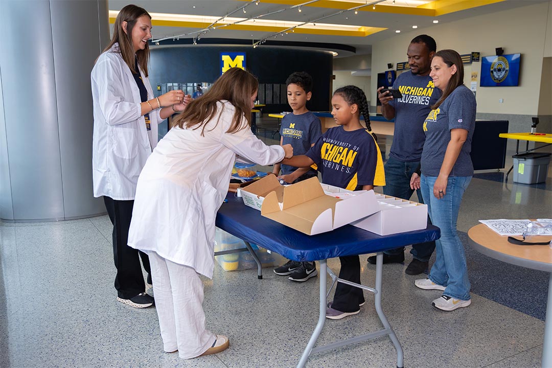 Two kids doing crafts at a Michigan event