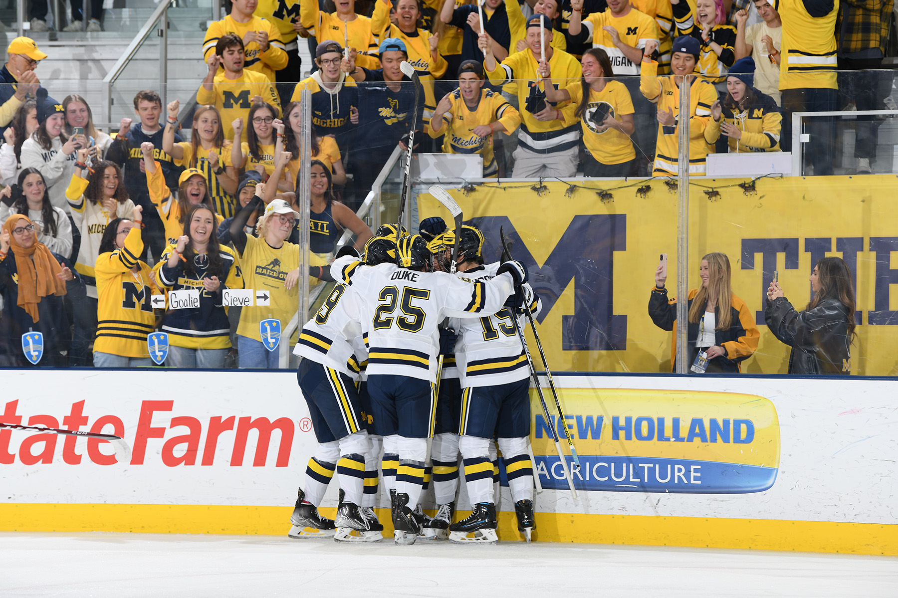 Michigan Hockey celebrates a goal in front of the Children of Yost