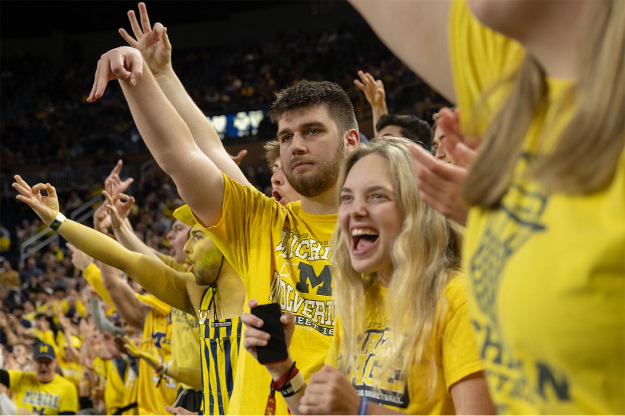 Fans cheering in maize t-shirts