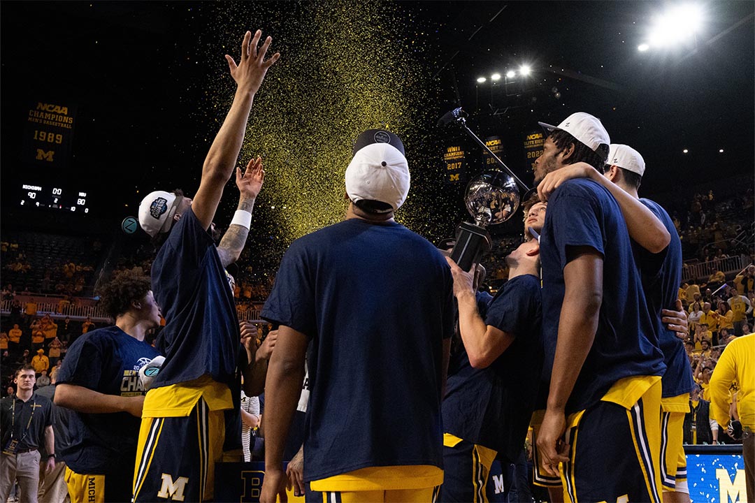 Michigan men's basketball team celebrates the Big Ten regular-season title with confetti falling at Crisler