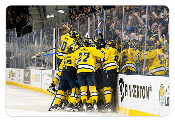 Michigan celebrating after beating Michigan State