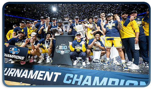 Men's basketball celebrates the Big Ten Tournament title with the trophy and confetti falling