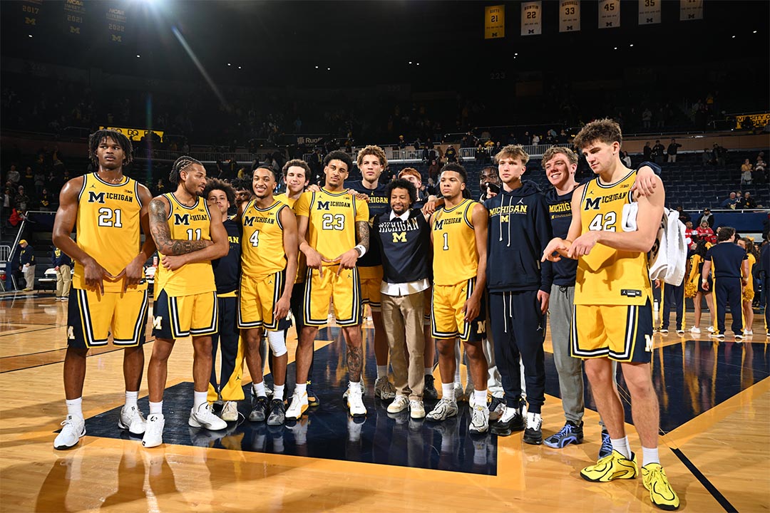 Michigan men's basketball team on the court with Trey Burke